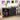 Black entertainment console with records and a turntable in a room with vinyl records on the wall.