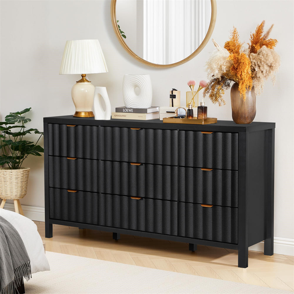 Black dresser with decorative items in a bedroom setting