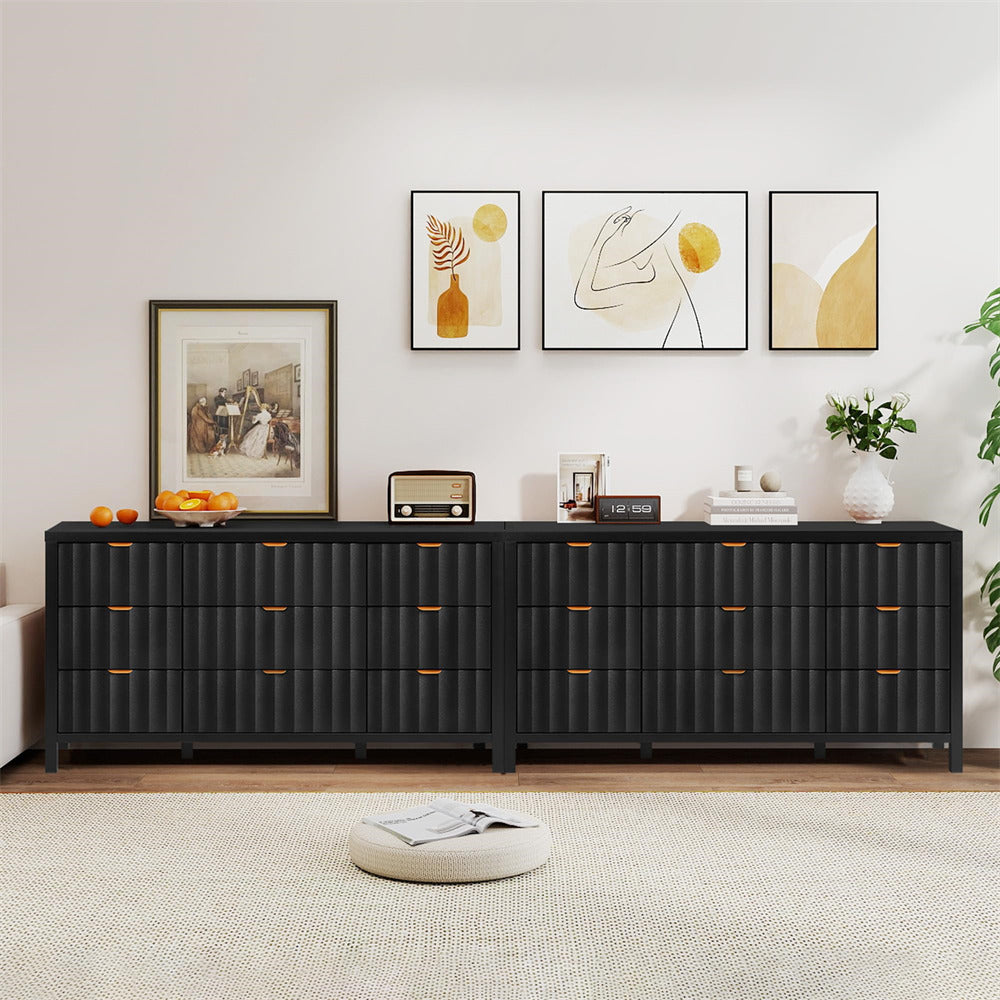 Black sideboard in a living room with decorative items and wall art.