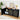 Black sideboard with decorative items in a room with a plant and framed picture.