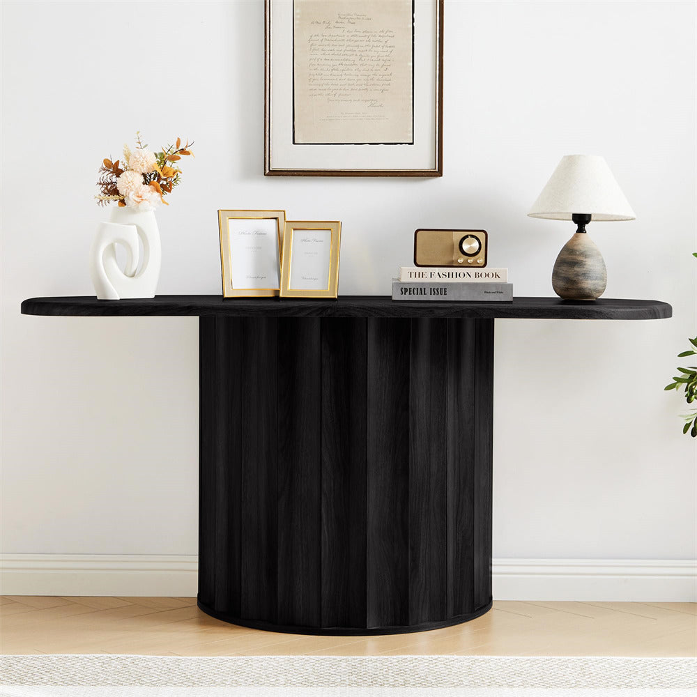 Black console table with decorative items against a white wall