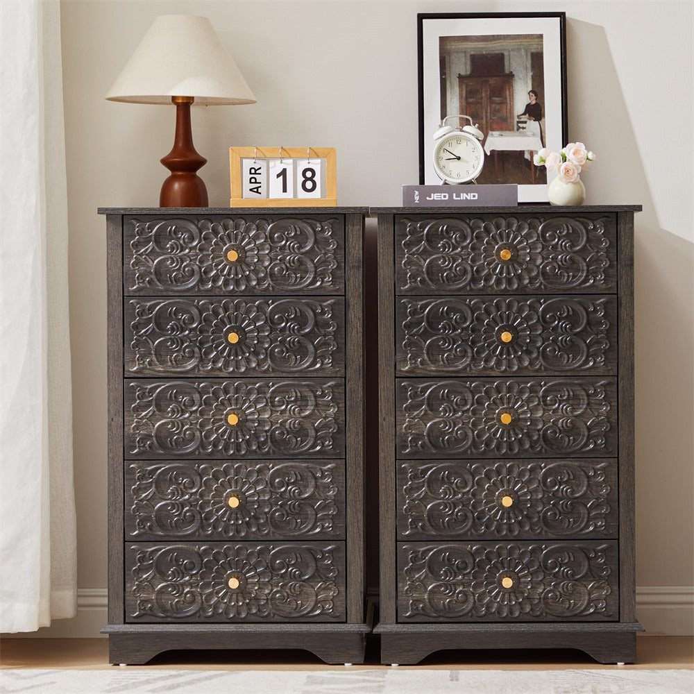 Decorative chest of drawers with ornate carvings in a room setting.