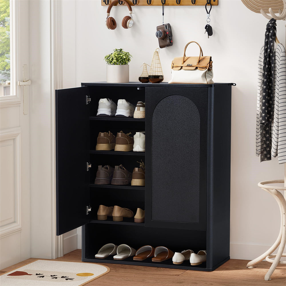 Black shoe cabinet with open doors displaying shoes, placed in a room with decor elements.