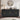Black sideboard with gold handles in a room setting with decor items.