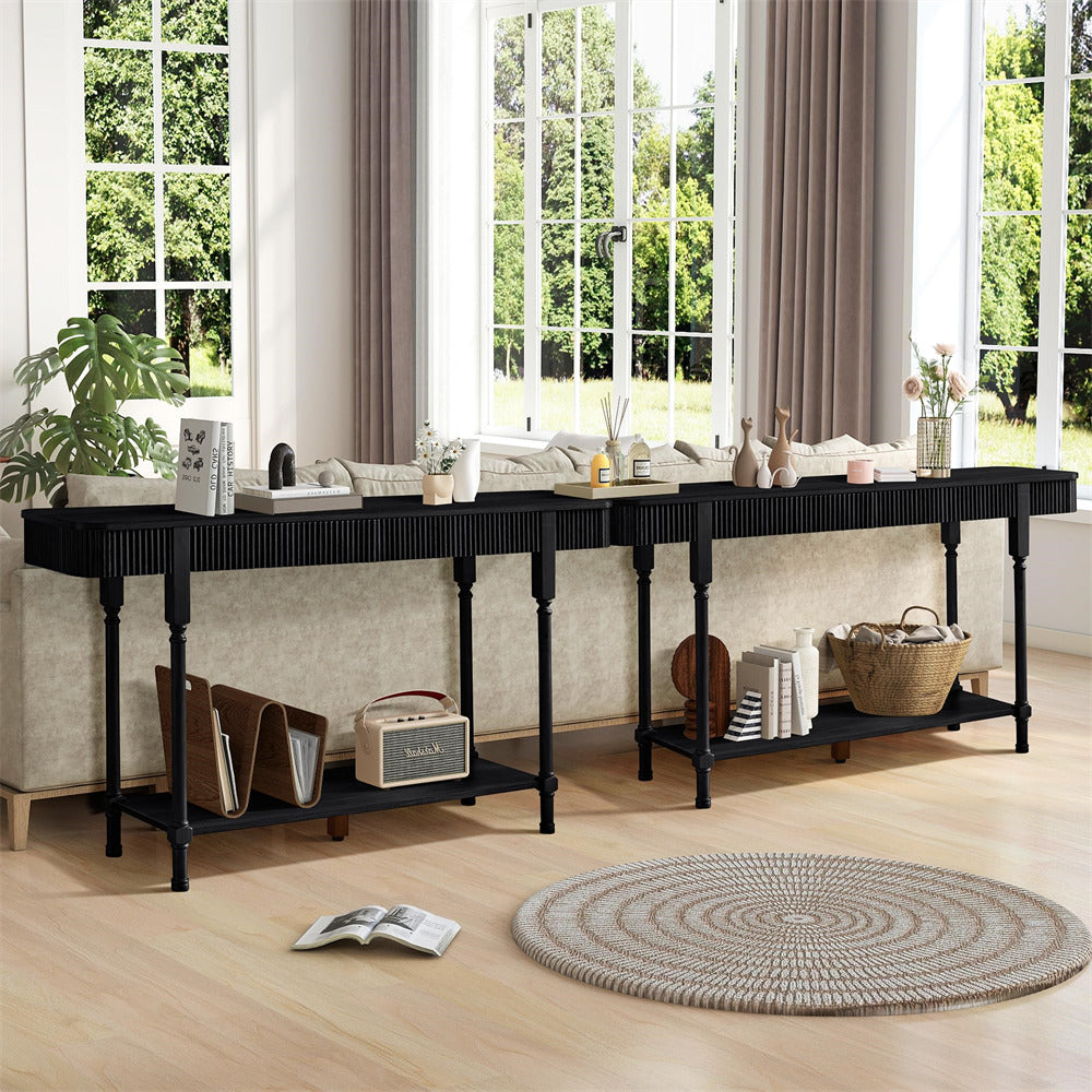 Long black console table with shelves in a living room setting.