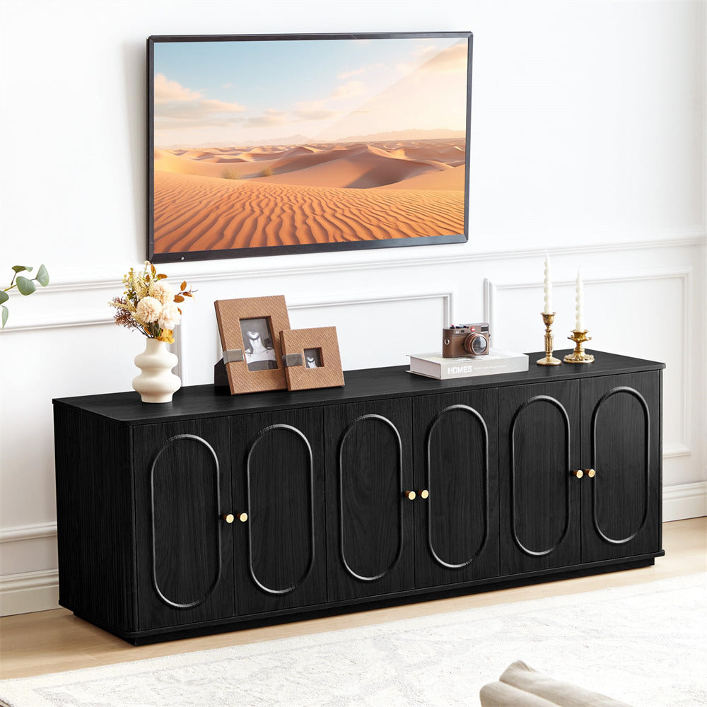 Black entertainment console with decorative items in a living room setting