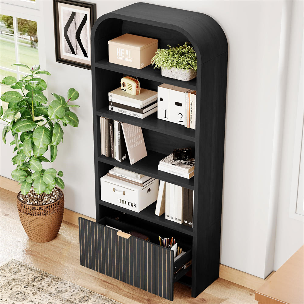 Black bookshelf with decorative items in a room with a plant and framed picture.