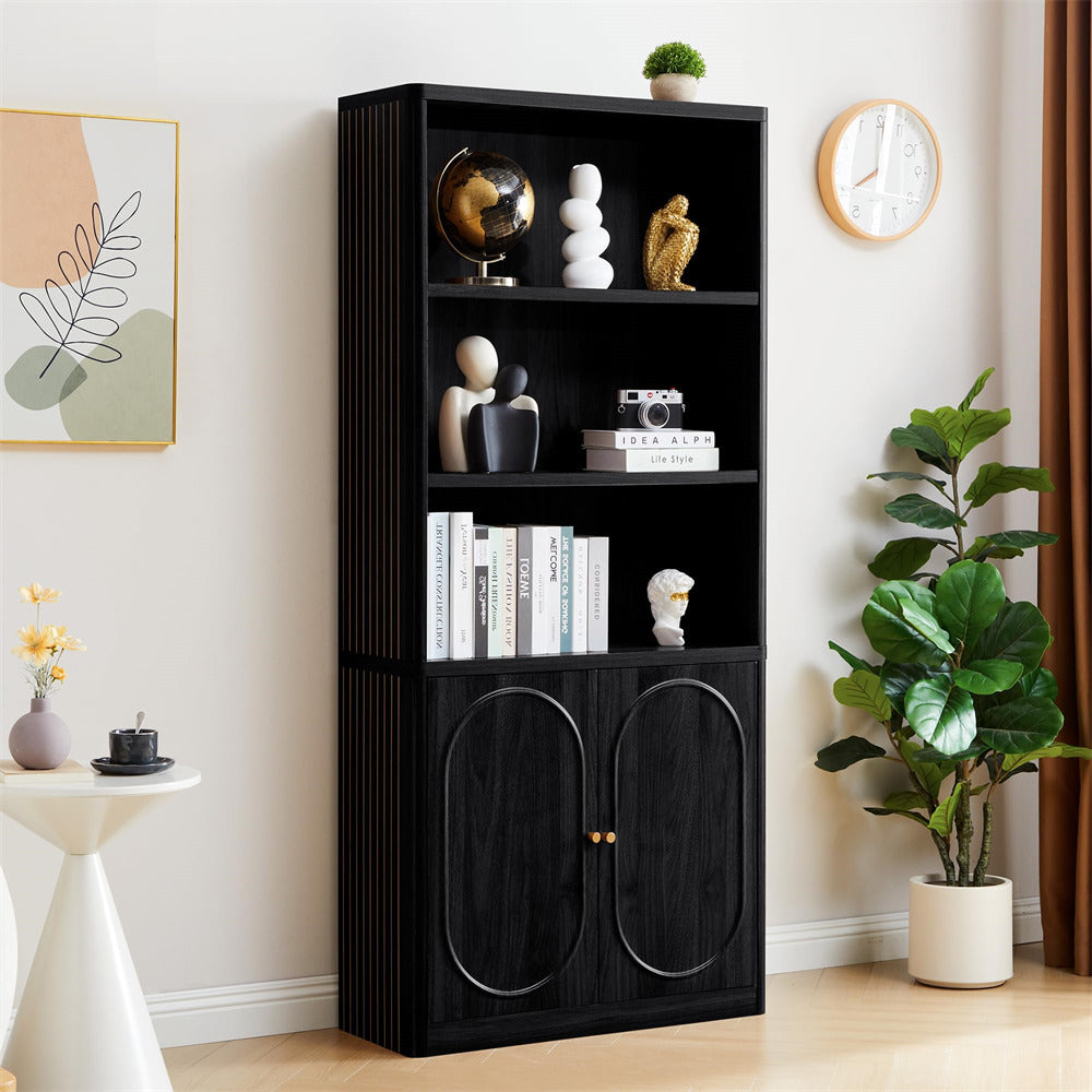 Black bookshelf with decorative items in a room with a plant and wall art.