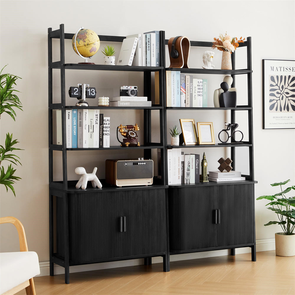 Black bookshelf with decorative items in a room with plants and a chair.