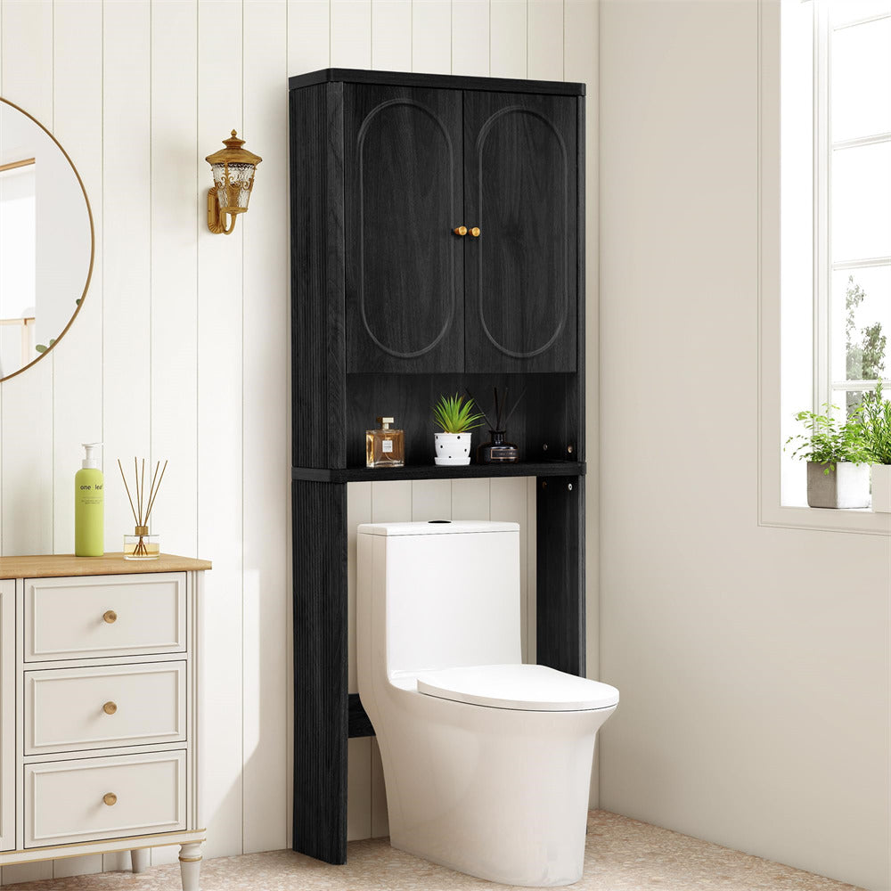 Black over-the-toilet cabinet in a bathroom setting with white walls and decor.