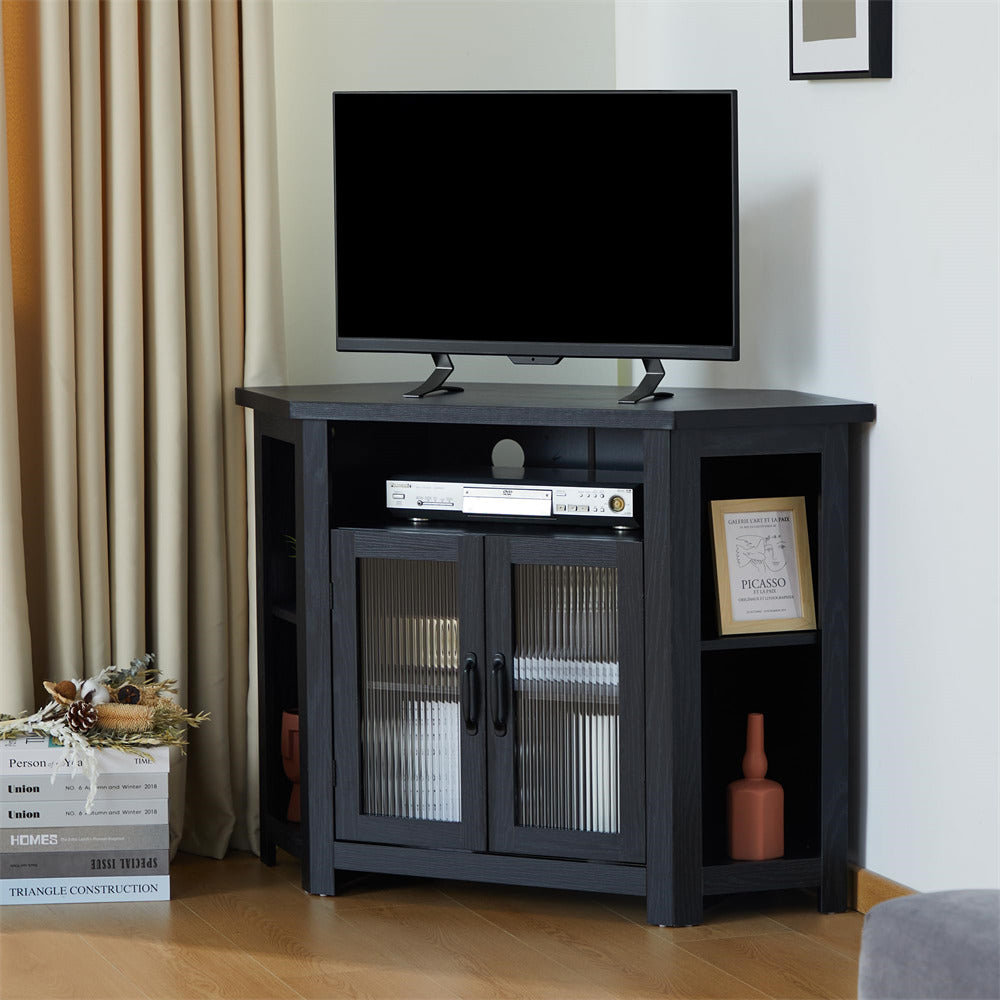 Black TV stand with a television and decorative items in a living room setting.