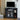 Black TV stand with a television and decorative items in a living room setting.