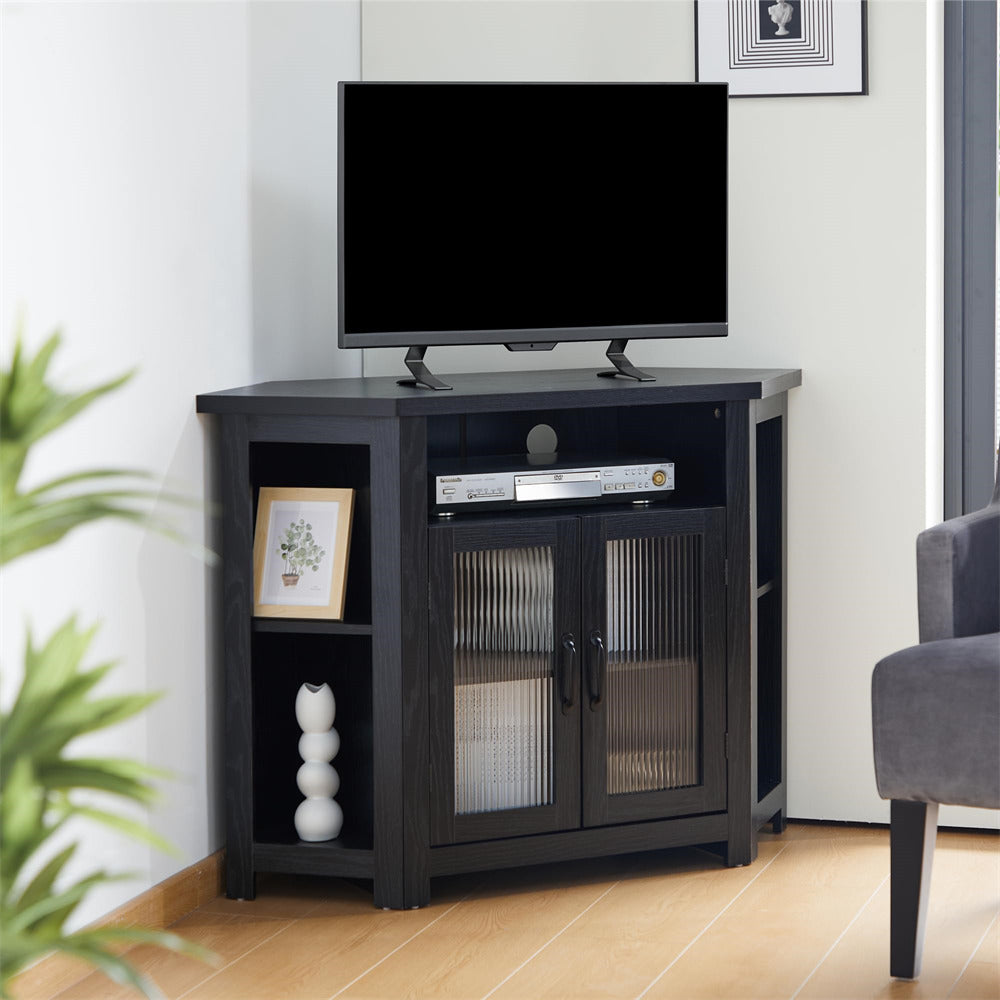 Black corner TV stand with a television on top in a living room setting.