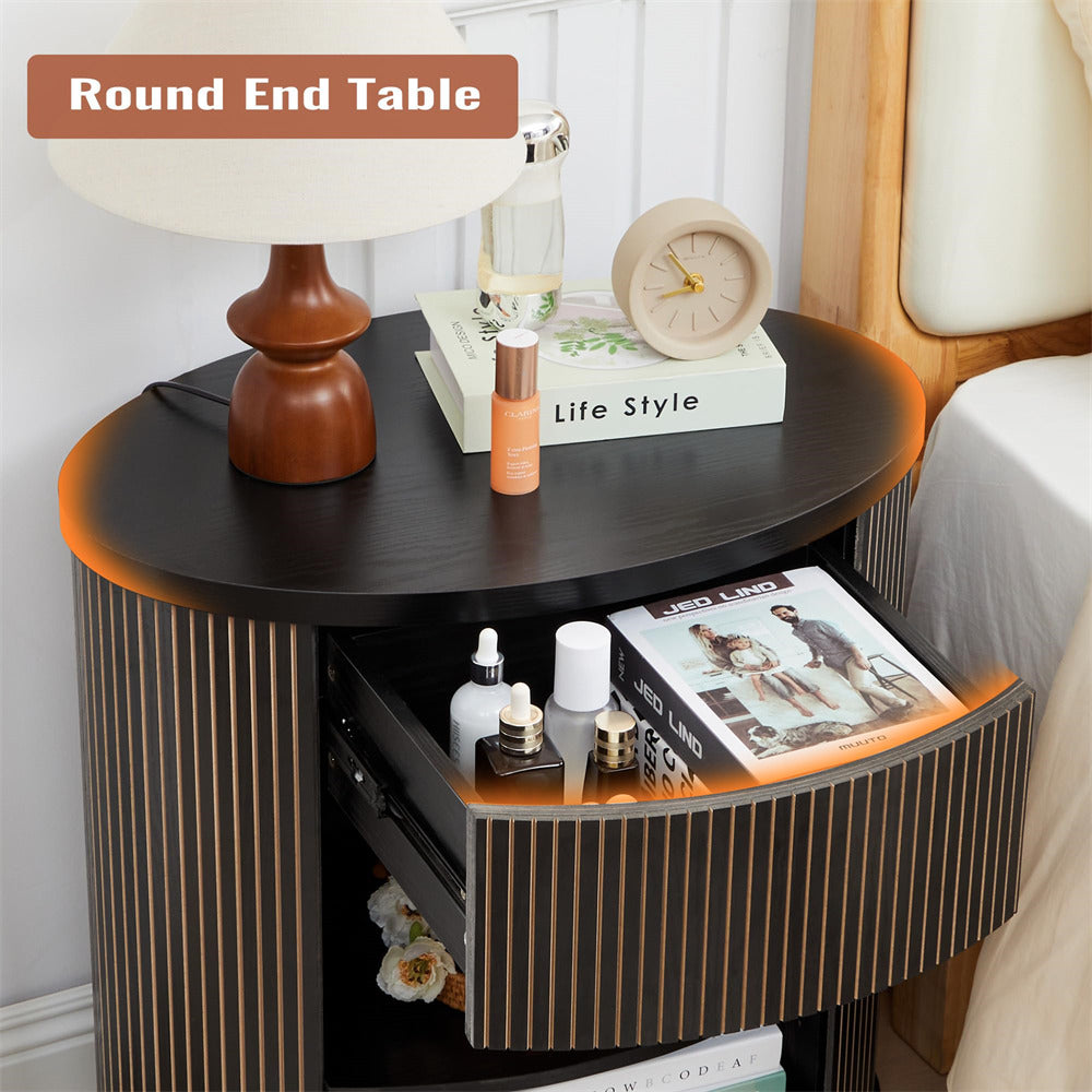 Round end table with various items on top in a bedroom setting