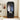 Black wardrobe with clothes hanging inside in a room setting