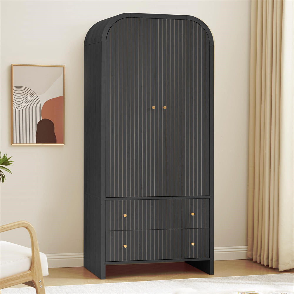Black wardrobe with gold handles in a room with a painting and chair.