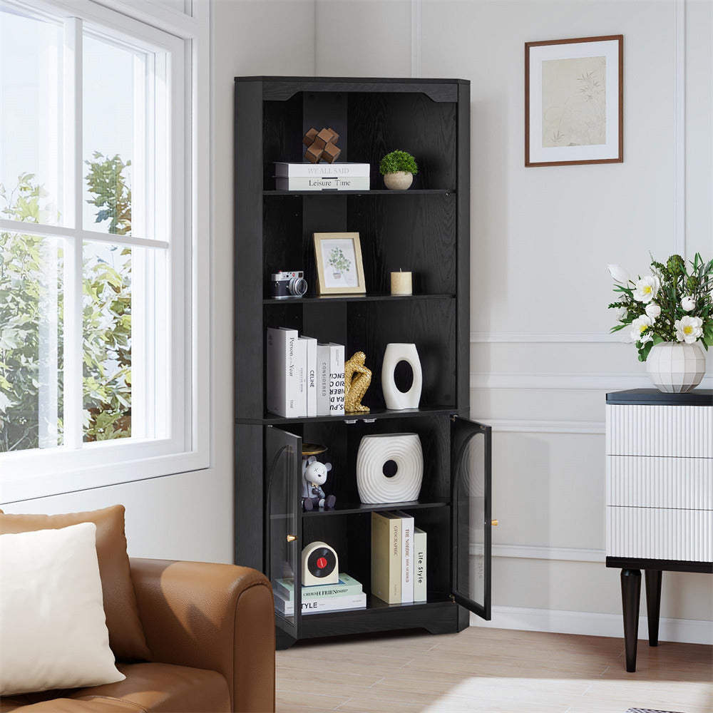 Black bookshelf in a living room with decor items against a window.