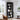 Black bookshelf in a living room with decor items against a window.