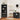 Bathroom interior with black shelving units, sink, and mirror.