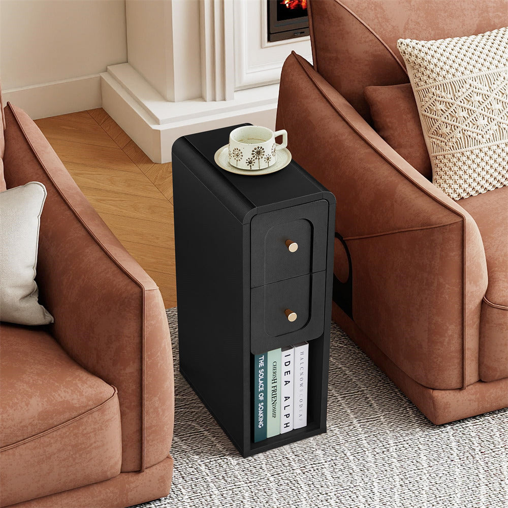 Black side table with a cup and saucer next to a brown sofa in a living room.