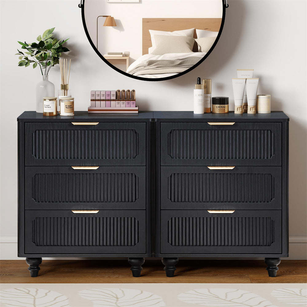 Black dresser with decorative items in a bedroom setting
