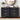 Black dresser with decorative items in a bedroom setting