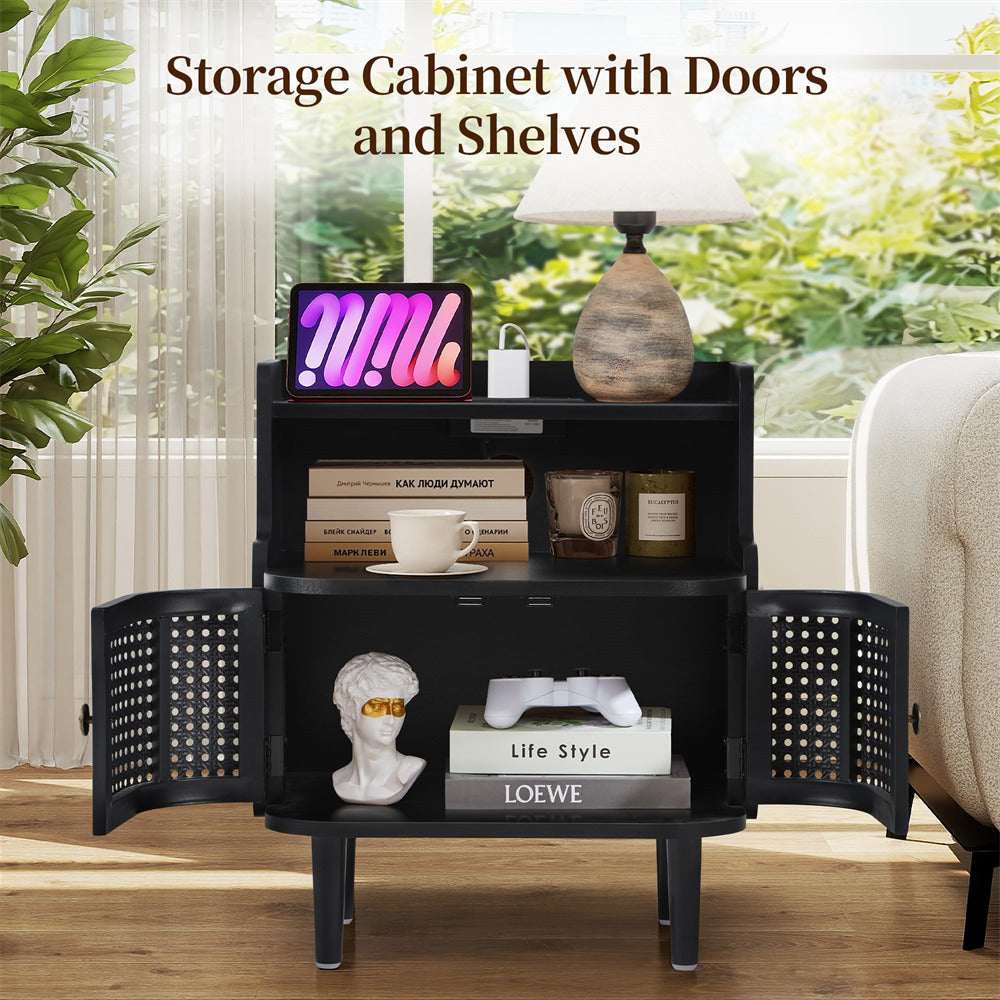 Black storage cabinet with doors and shelves in a room with plants and a couch.