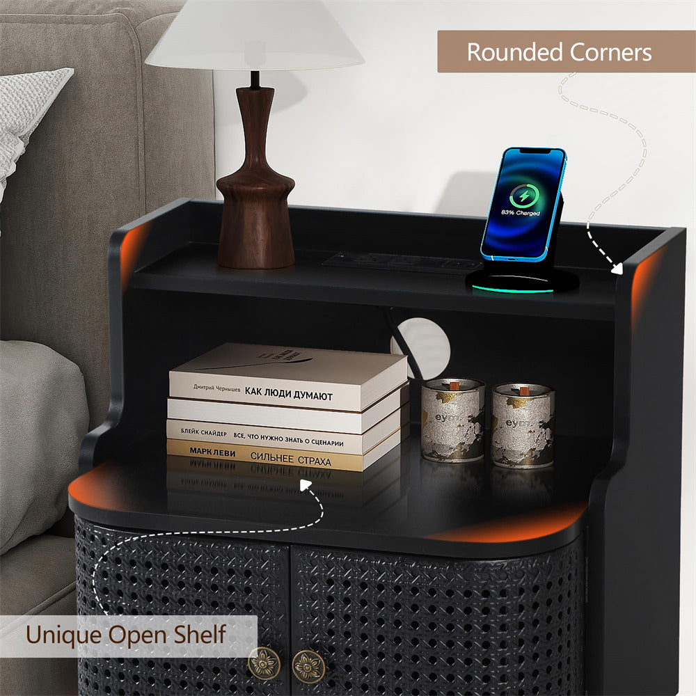 Black nightstand with open shelf, books, lamp, and smartphone on a neutral background