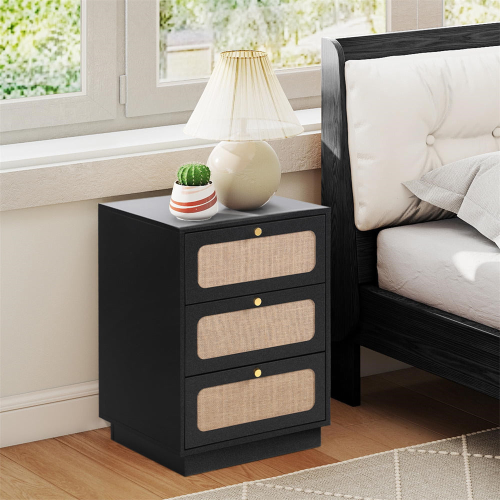 Black nightstand with three drawers next to a bed in a bedroom.