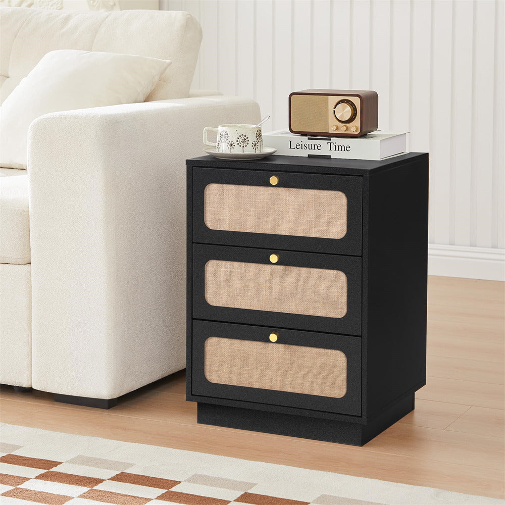 Black nightstand with beige drawers next to a white sofa in a living room.