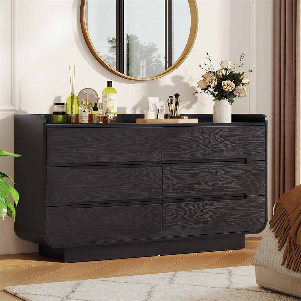 Black 6-drawer dresser with decorative items in a room setting