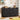Black 6-drawer dresser in a room with toys, books, and decor items on top