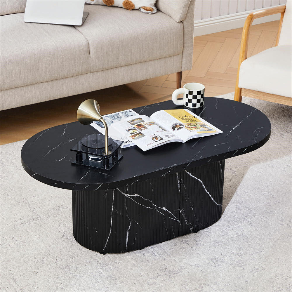 Black marble coffee table with a magazine and cup in a living room setting