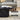 Black marble coffee table with curved top and fluted design in a living room setting.