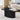 Black marble coffee table in a living room with a magazine and mug on top