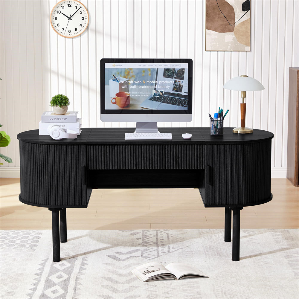 Black desk with a computer setup in a home office setting.