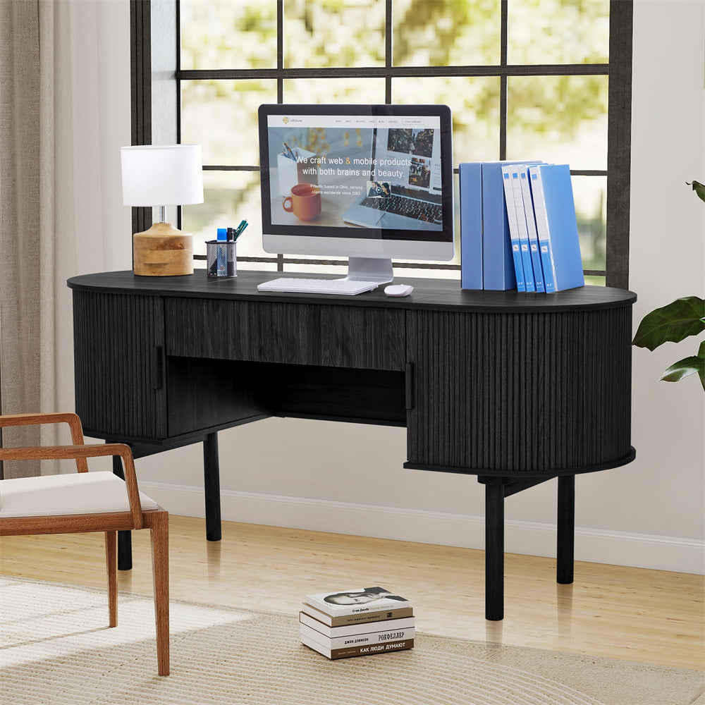 Black corner desk with computer setup in a home office setting