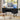 Black corner desk with computer setup in a home office setting