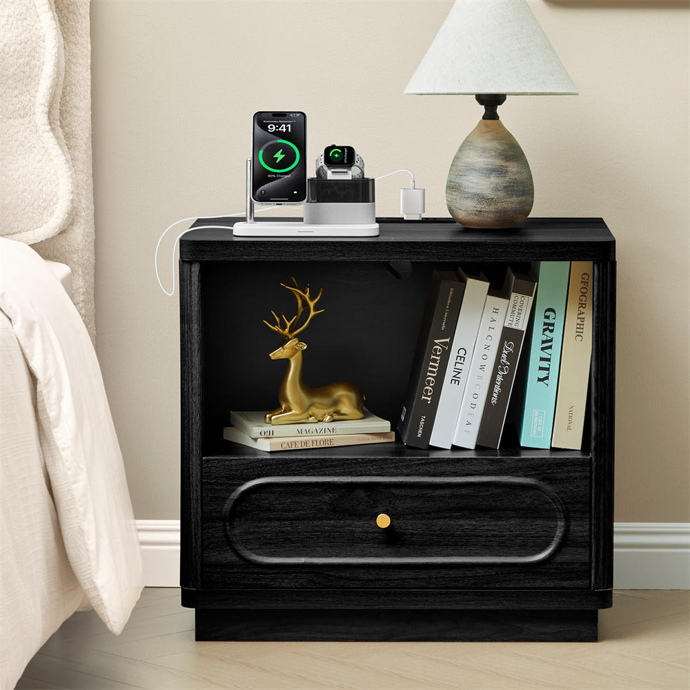 Black nightstand with books, a lamp, and decorative items in a bedroom setting.
