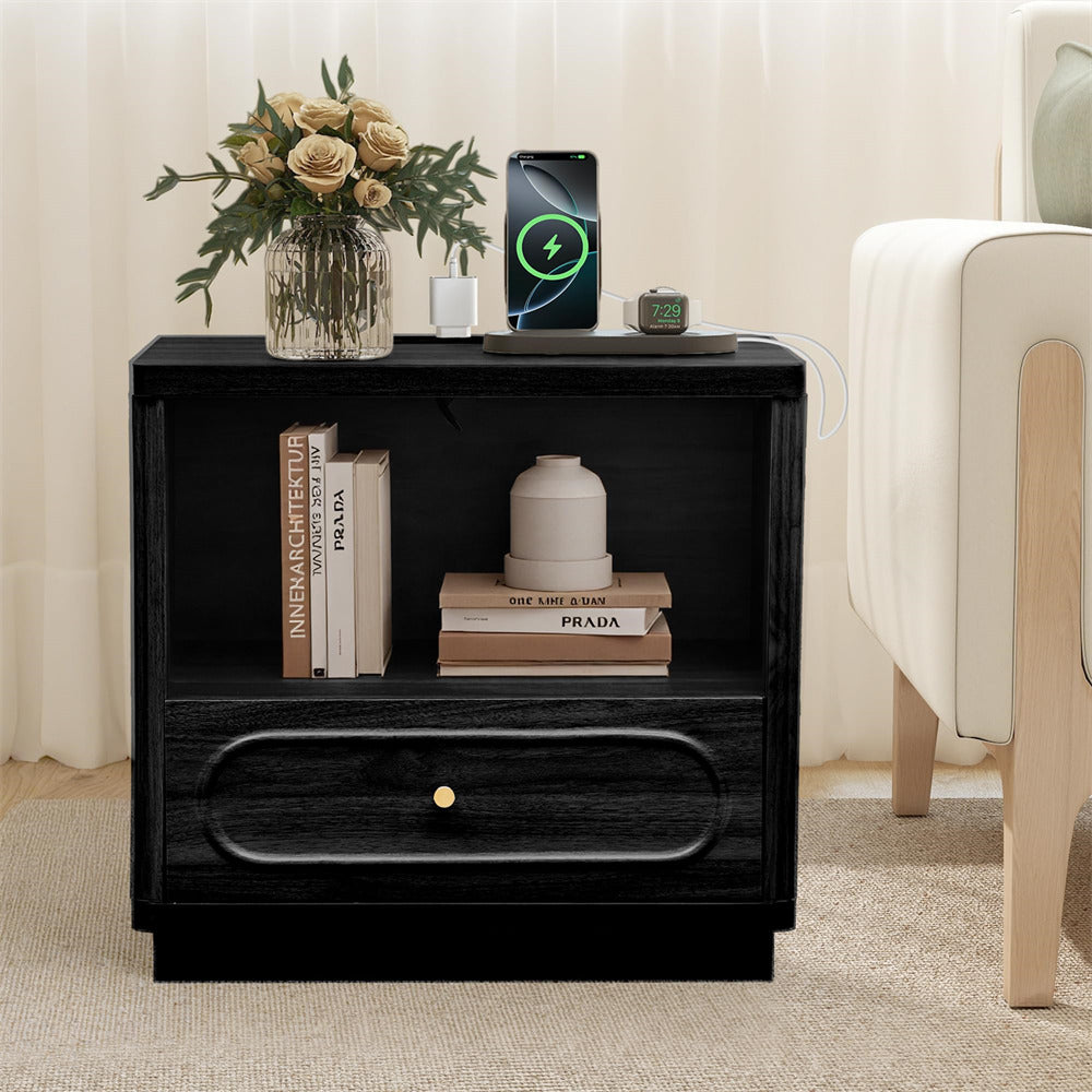 Black nightstand with books, a vase of flowers, and a smartphone in a living room setting.