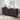 Black cabinet with geometric pattern on a wooden floor, featuring decor items.