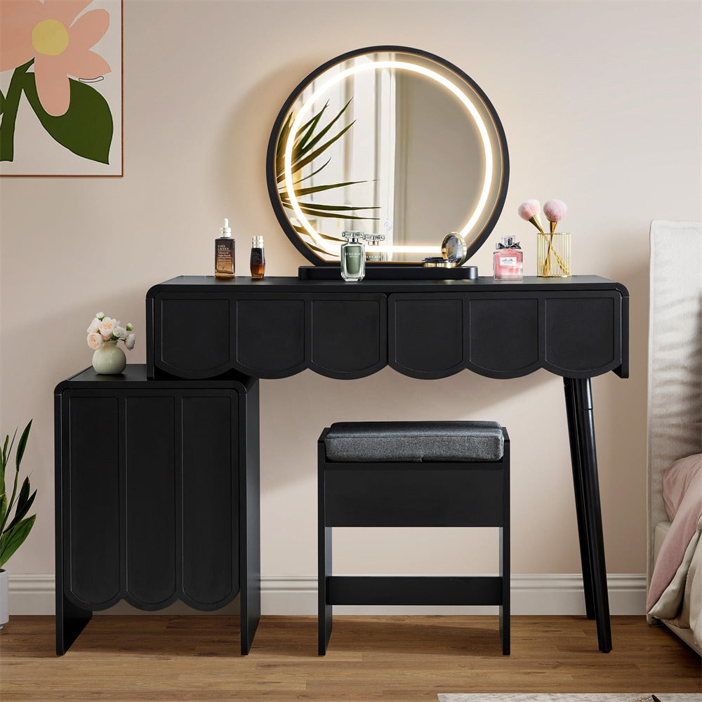 Black vanity table with round mirror and stool in a room setting