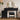 Black vanity table with round mirror and stool in a room setting