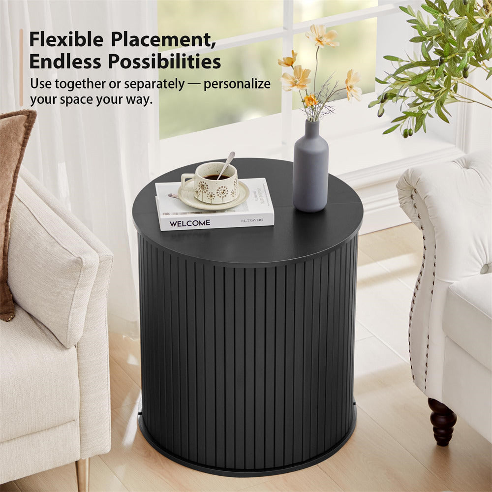Black side table with decor items in a living room setting
