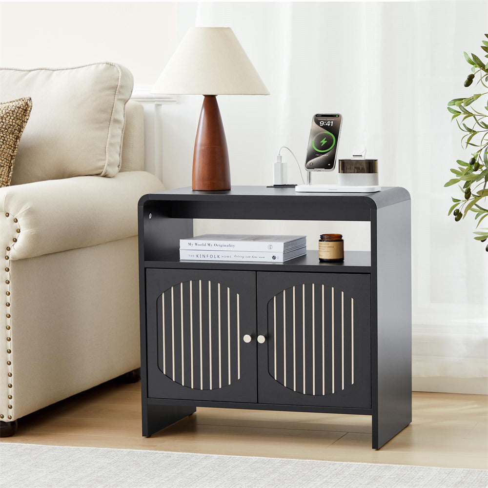 Black side table with decorative items in a living room setting