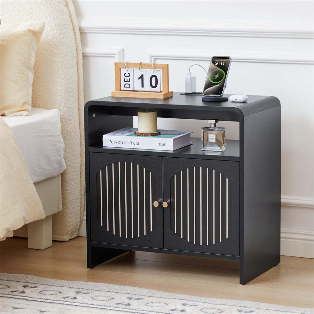 Black nightstand with decorative items in a bedroom setting