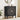 Black cabinet with circular design in a room with a plant and mirror.