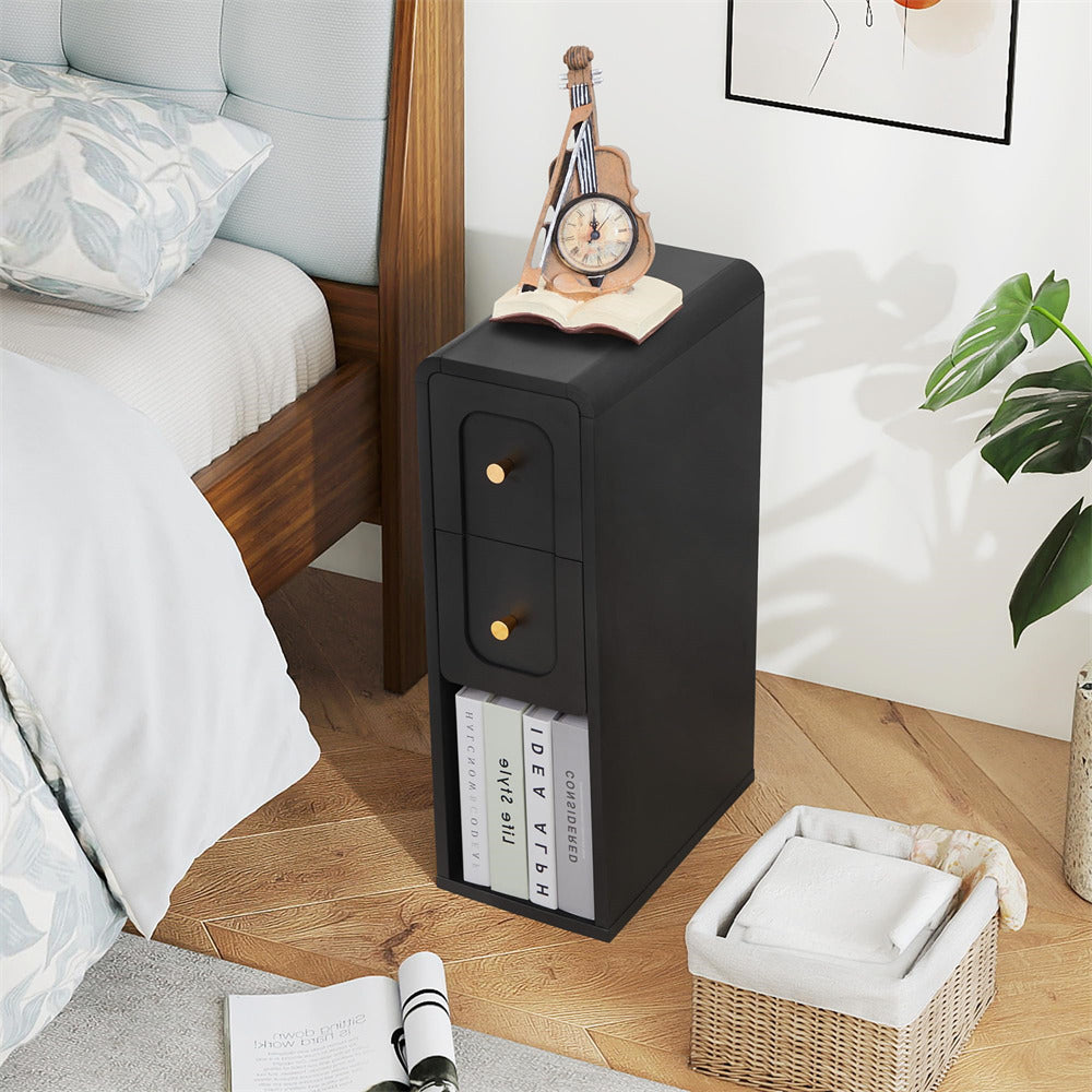 Black nightstand with a clock and books next to a bed in a bedroom.