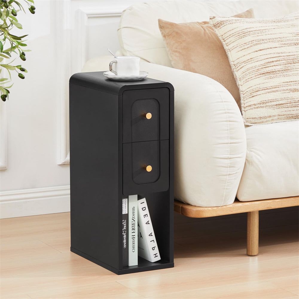 Black side table with books next to a bed in a bedroom setting
