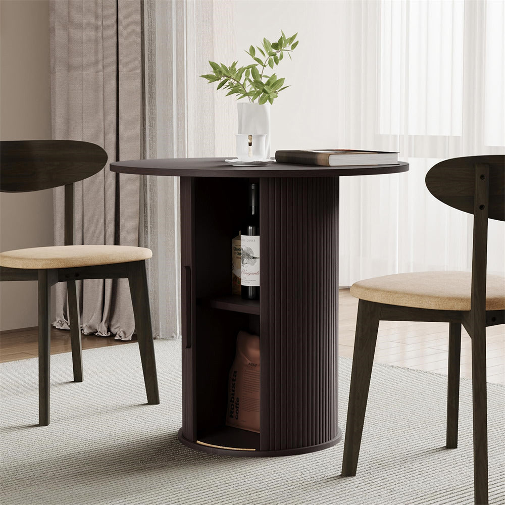 Round dark wood dining table with stools in a room with curtains and a plant.